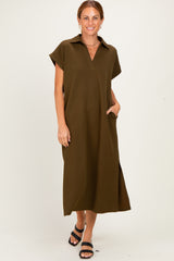 woman wearing an olive green short sleeve maxi dress with a collar and side pockets