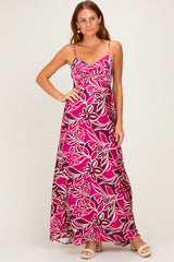 woman wearing a pink floral maxi dress with adjustable spaghetti straps and a flowy silhouette