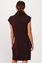 woman wearing a brown sleeveless sweater dress with a cowl neck and a relaxed fit, shown from the back