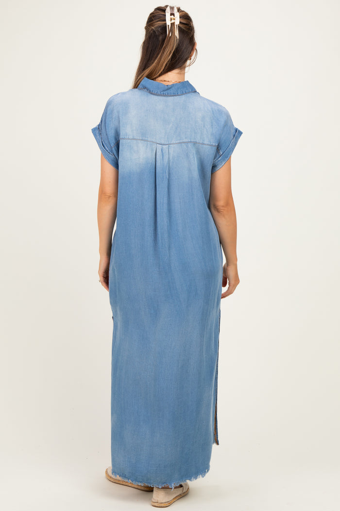 woman wearing a light blue denim maxi dress with short sleeves and side slits, showcasing her baby bump