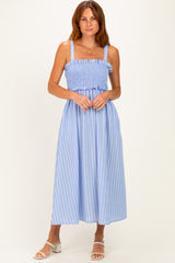 woman wearing a light blue striped maxi dress with a smocked bodice and adjustable straps