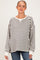 woman wearing a striped maternity sweater in gray and white with a relaxed fit and v-neck design