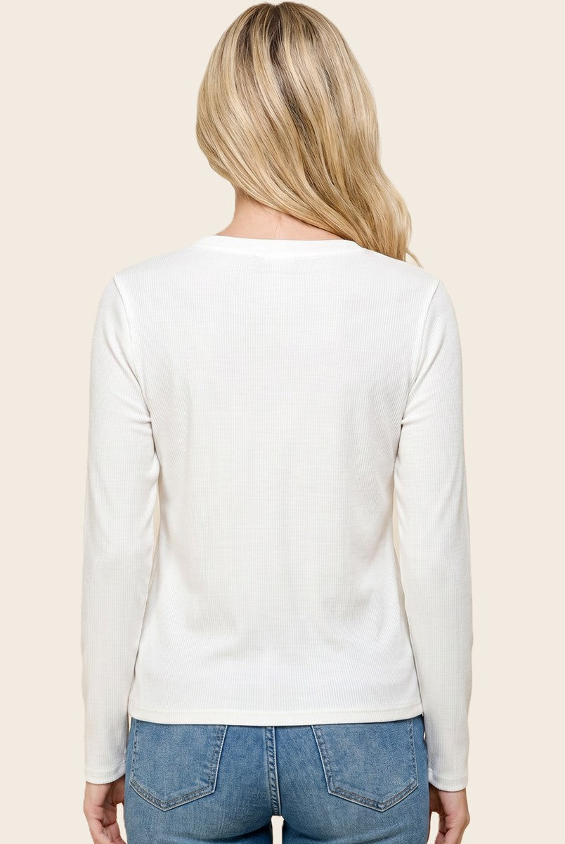 woman wearing a white long sleeve ribbed top styled with light blue jeans, viewed from the back