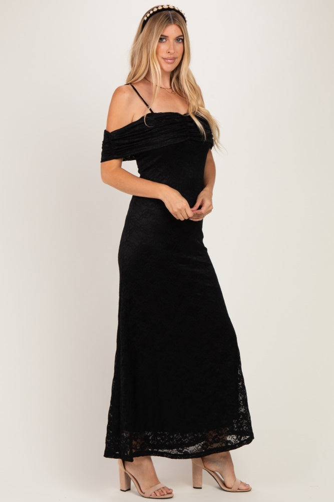 woman wearing a black off-shoulder lace maxi dress with thin straps and a fitted silhouette