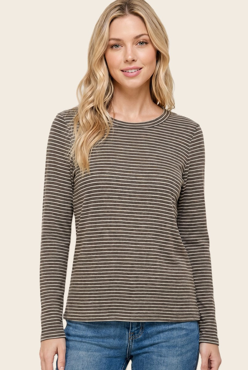 woman wearing a brown and cream striped long sleeve top with a round neckline and relaxed fit