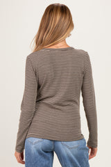 woman wearing a striped long sleeve maternity top viewed from the back with blue jeans