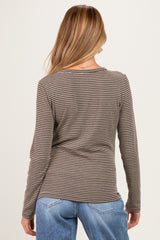 woman wearing a striped long sleeve maternity top viewed from the back with blue jeans