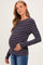 woman wearing a navy blue and red striped maternity top highlighting her baby bump