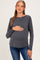 woman wearing a dark gray maternity long sleeve top and holding her baby bump