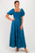 woman wearing a teal square neck maxi dress with puff sleeves and embroidered details, standing against a white background