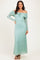 woman wearing a light teal off-the-shoulder lace maxi dress with long sleeves and a drawstring detail
