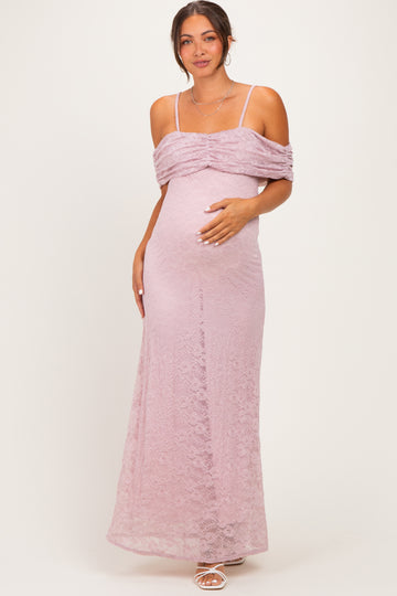woman wearing a light purple lace maternity gown with off-shoulder design and a visible baby bump