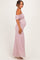 woman wearing a light pink off-shoulder lace maternity gown with a visible baby bump