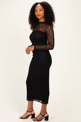 woman wearing a black long sleeve lace dress with a fitted silhouette and sheer detailing, paired with black strappy heels