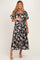 woman wearing a navy floral maternity maxi dress and holding her baby bump