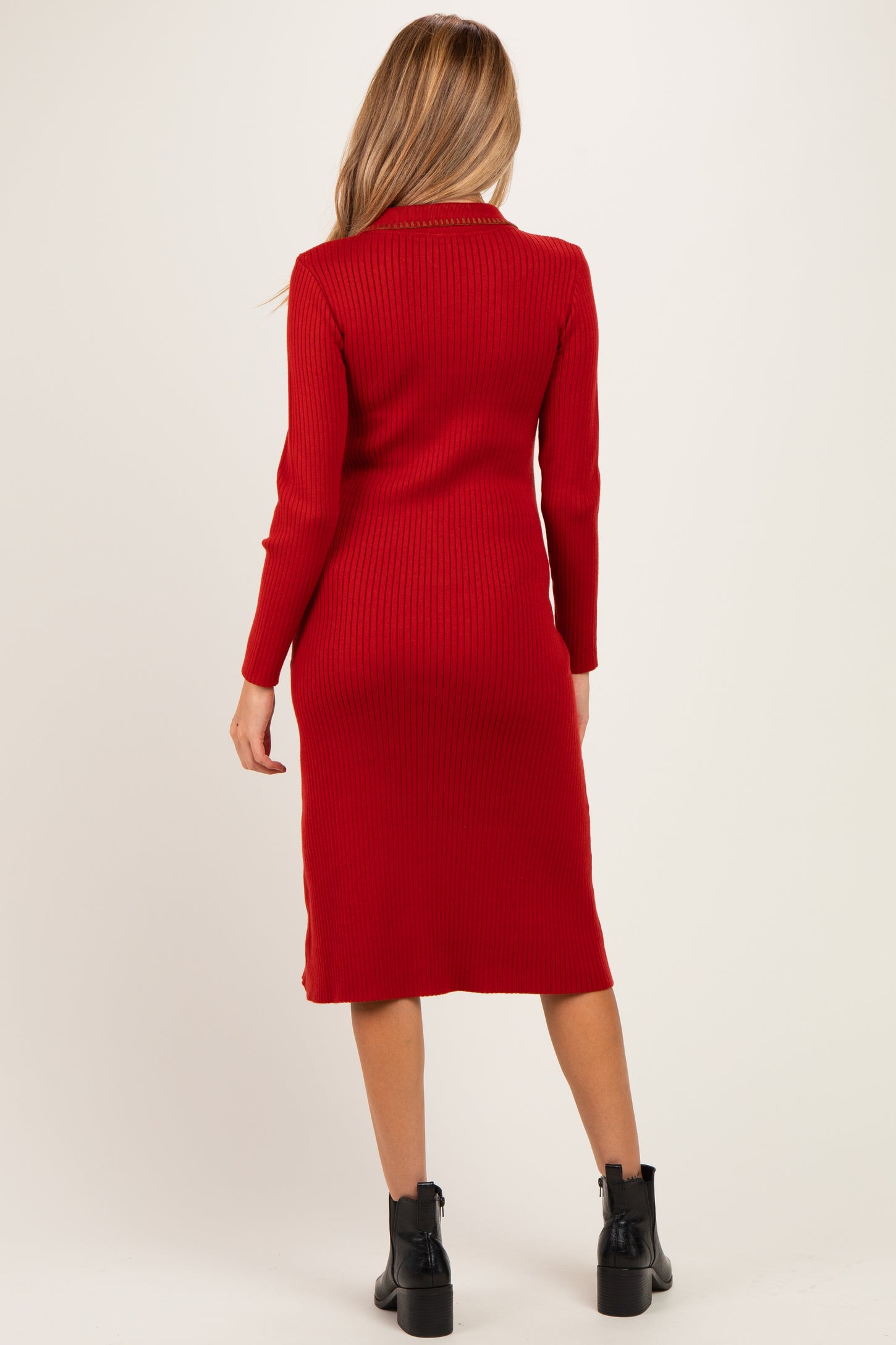 woman wearing a red ribbed midi maternity dress with long sleeves, viewed from the back