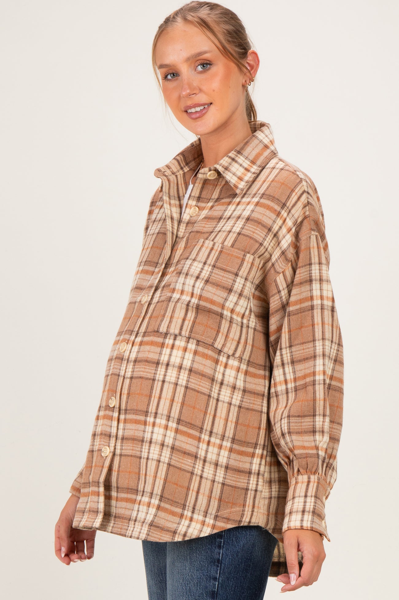woman wearing a brown plaid maternity shirt with a visible baby bump and relaxed fit