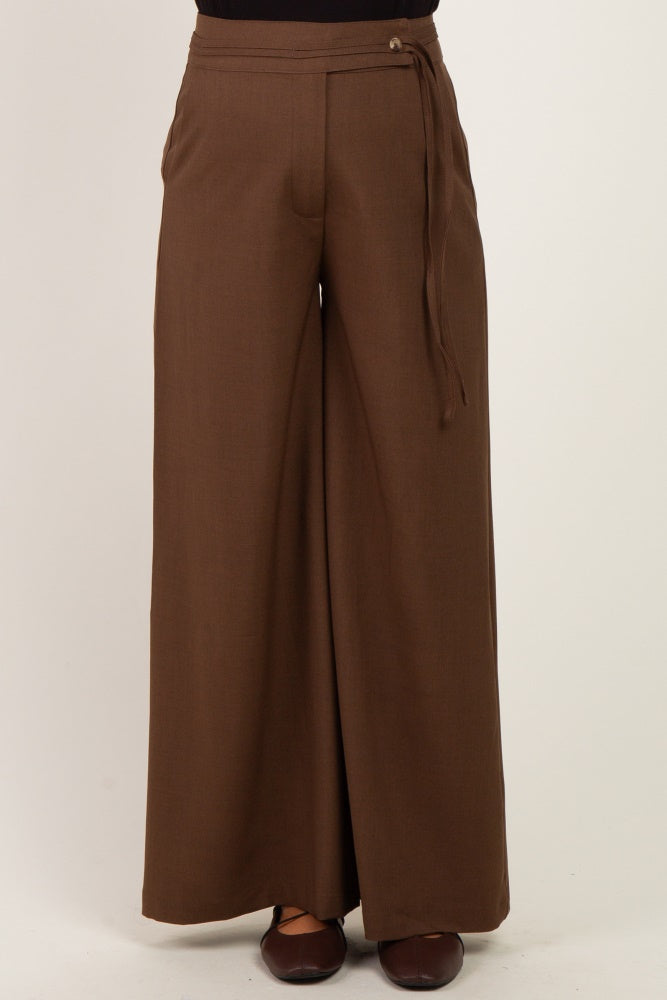 woman wearing brown wide-leg maternity pants with a tied waistband