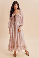 woman wearing a pink floral long sleeve maxi dress with a square neckline and bow detail