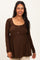 woman wearing a brown ribbed maternity top with button details and a visible baby bump