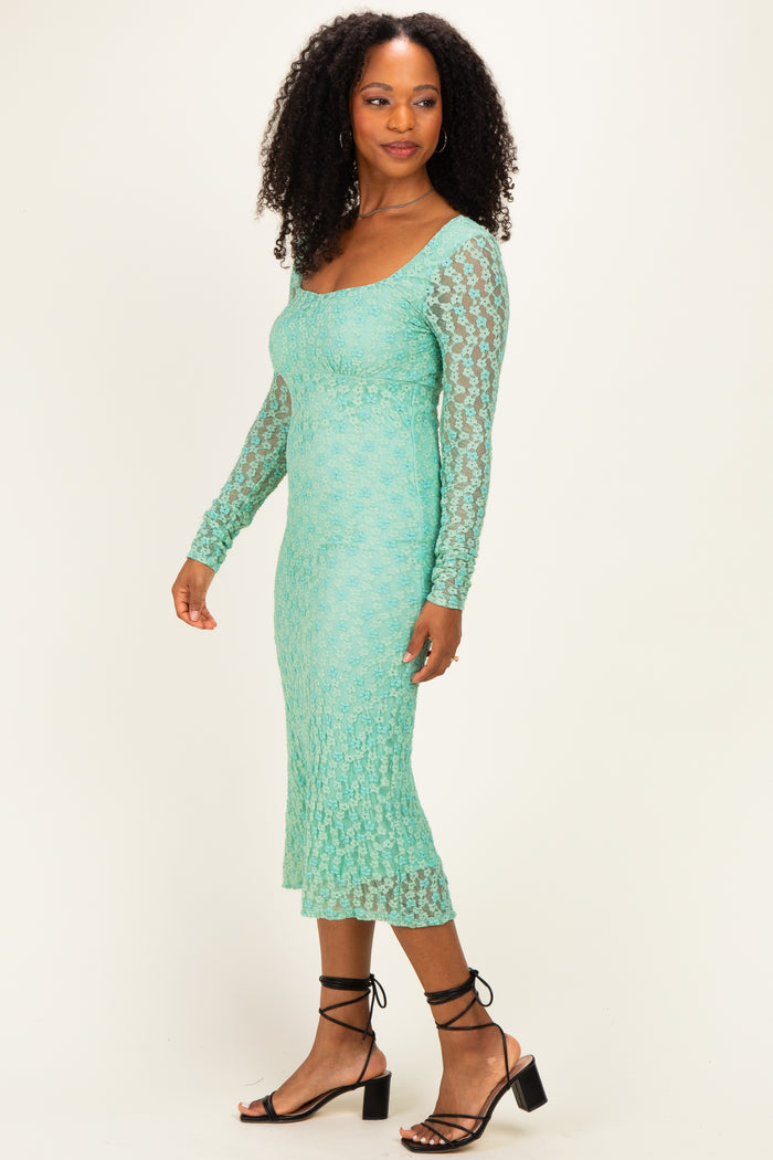 woman wearing a mint green lace long sleeve midi dress with a fitted silhouette and square neckline