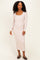woman wearing a light pink long sleeve ribbed midi dress with a square neckline