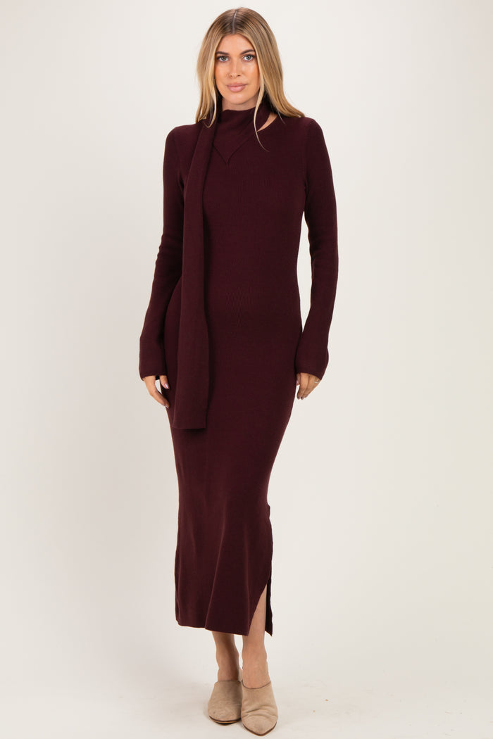 woman wearing a burgundy ribbed long sleeve knit dress with a side slit and matching scarf