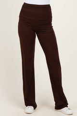 woman wearing brown wide-leg pants with a ruched waistband and a comfortable fit