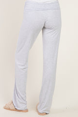 light gray lounge pants with a wide waistband, shown from the back, paired with slip-on slippers