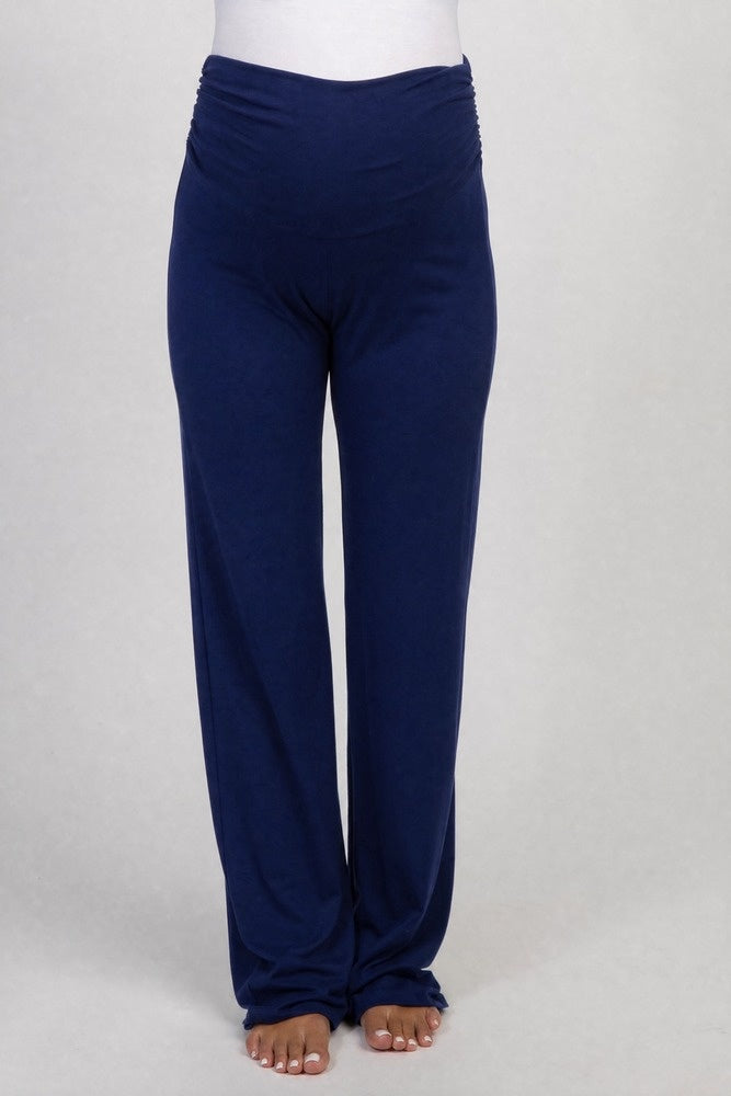 woman wearing navy blue maternity pants with a ruched waistband and a visible baby bump