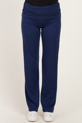 woman wearing navy blue wide-leg pants with a comfortable waistband and white sneakers