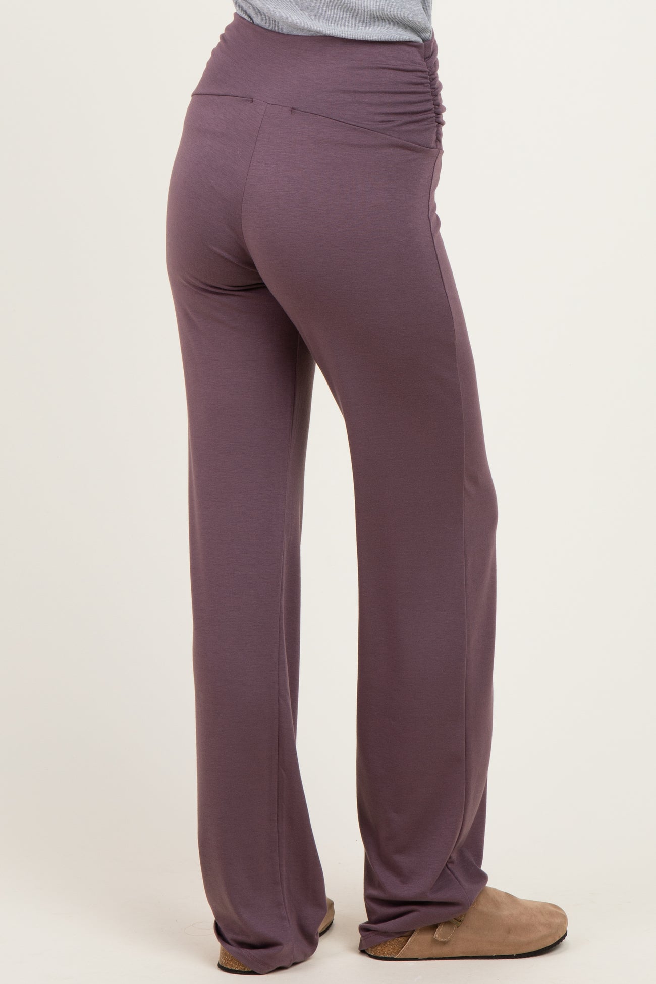 woman wearing purple ruched waistband pants viewed from the back