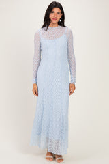 woman wearing a light blue long sleeve lace maxi dress with a fitted silhouette and high neckline