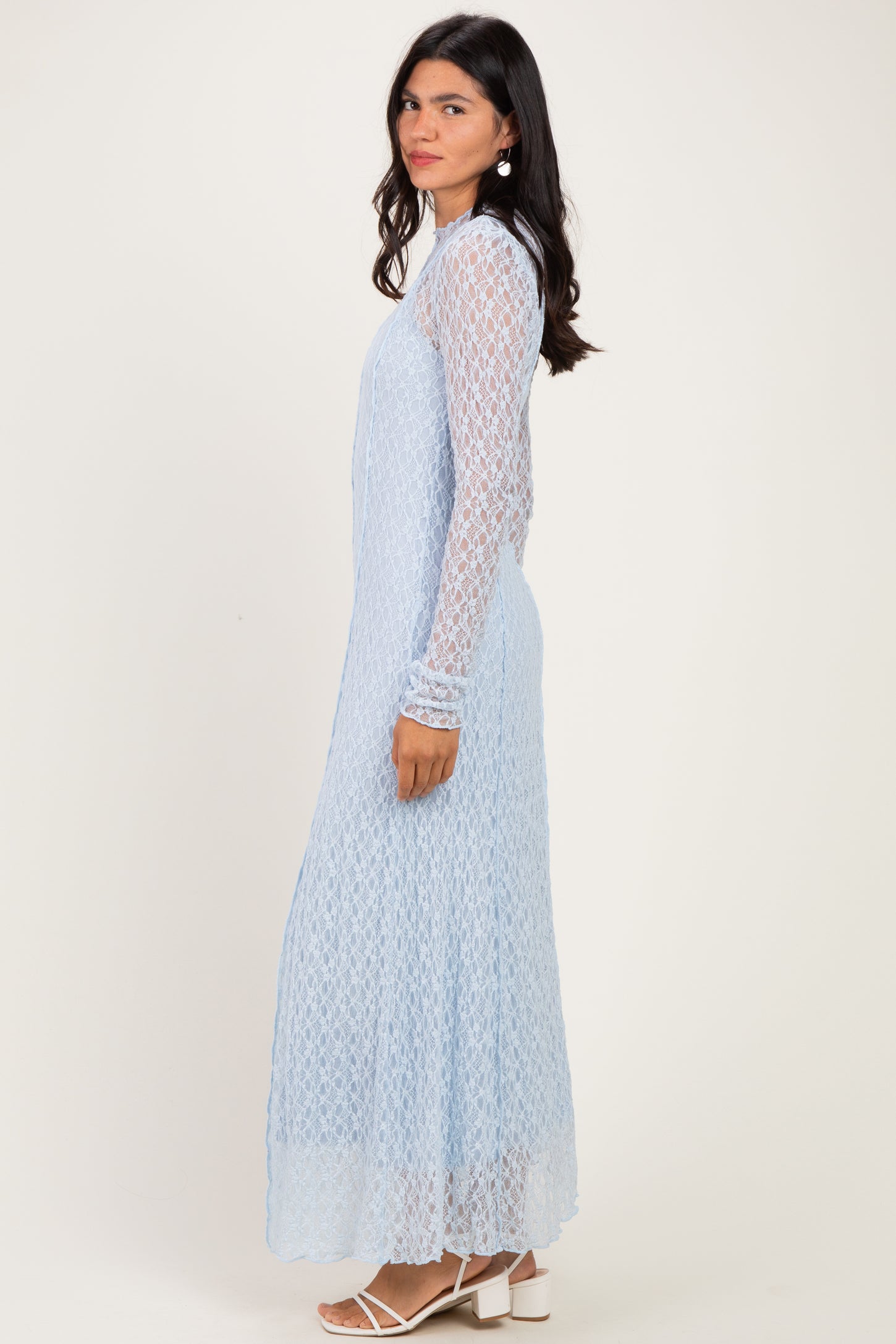 woman wearing a light blue long sleeve lace maxi dress with a flowy fit and side cutouts