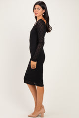 woman wearing a black lace long sleeve dress with a fitted silhouette and mid-calf length, styled with nude heels