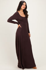 woman wearing a brown long sleeve maxi dress with a scoop neckline and flowing silhouette