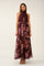 woman wearing a burgundy floral maxi dress with a halter neck and a tie waist detail