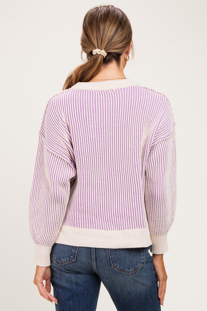 woman wearing a striped lavender and cream maternity sweater with balloon sleeves and a relaxed fit, seen from the back