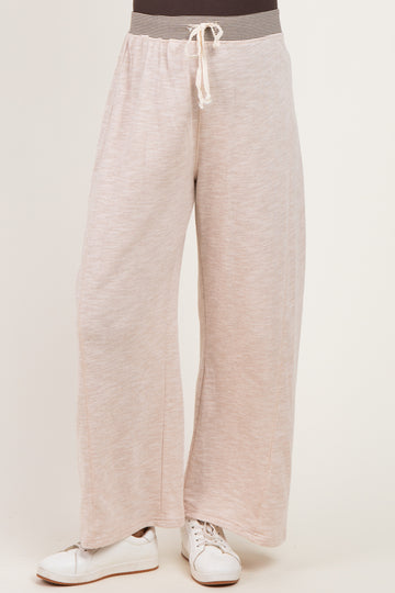 woman wearing light pink wide-leg maternity pants with drawstring waist