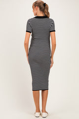woman wearing a black and white striped maternity dress, seen from the back