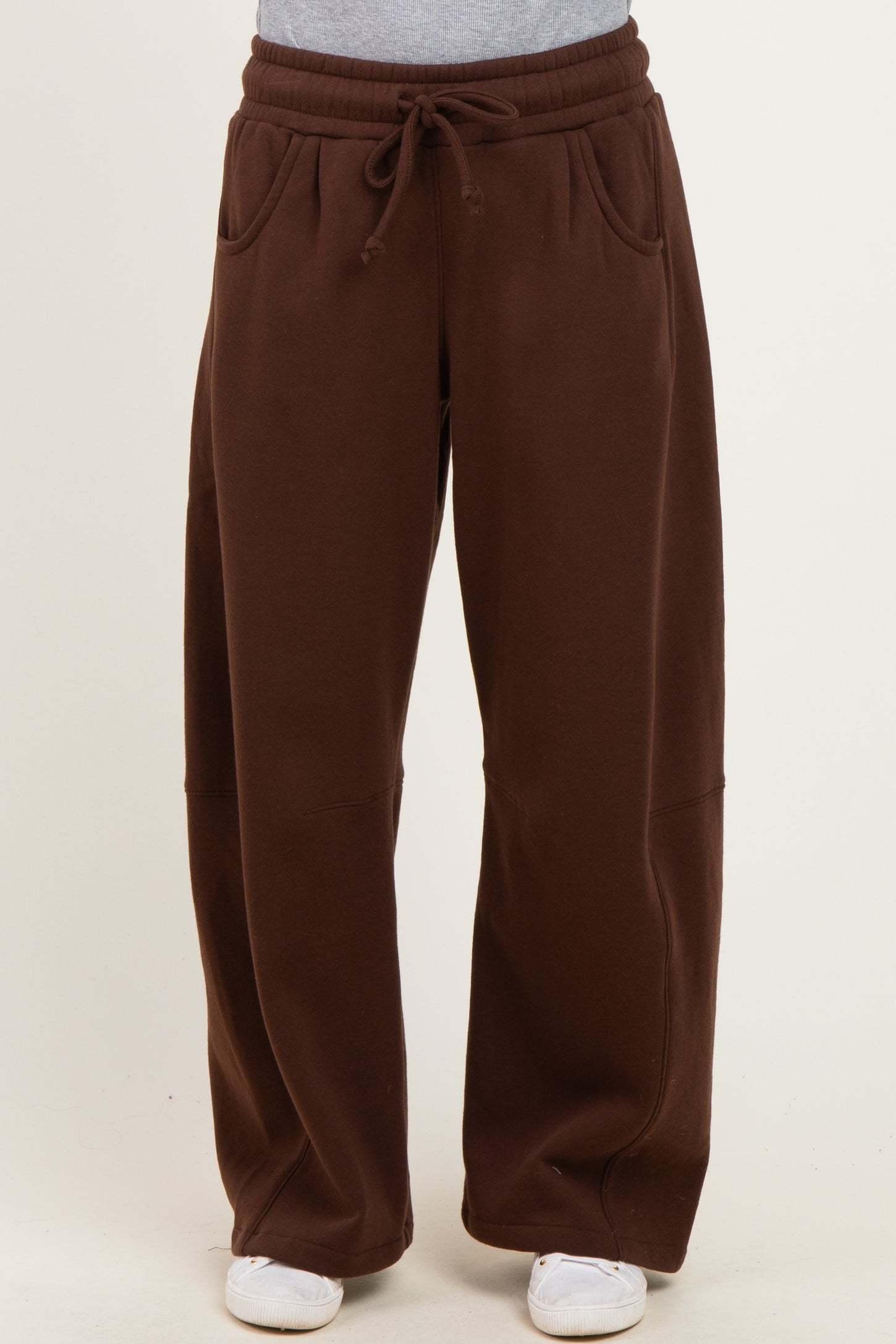 woman wearing brown wide-leg sweatpants with an elastic waistband and side pockets