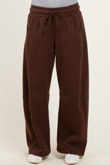 woman wearing brown wide-leg sweatpants with an elastic waistband and side pockets