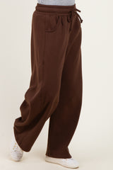 woman wearing brown wide-leg sweatpants with an elastic waistband and side pockets