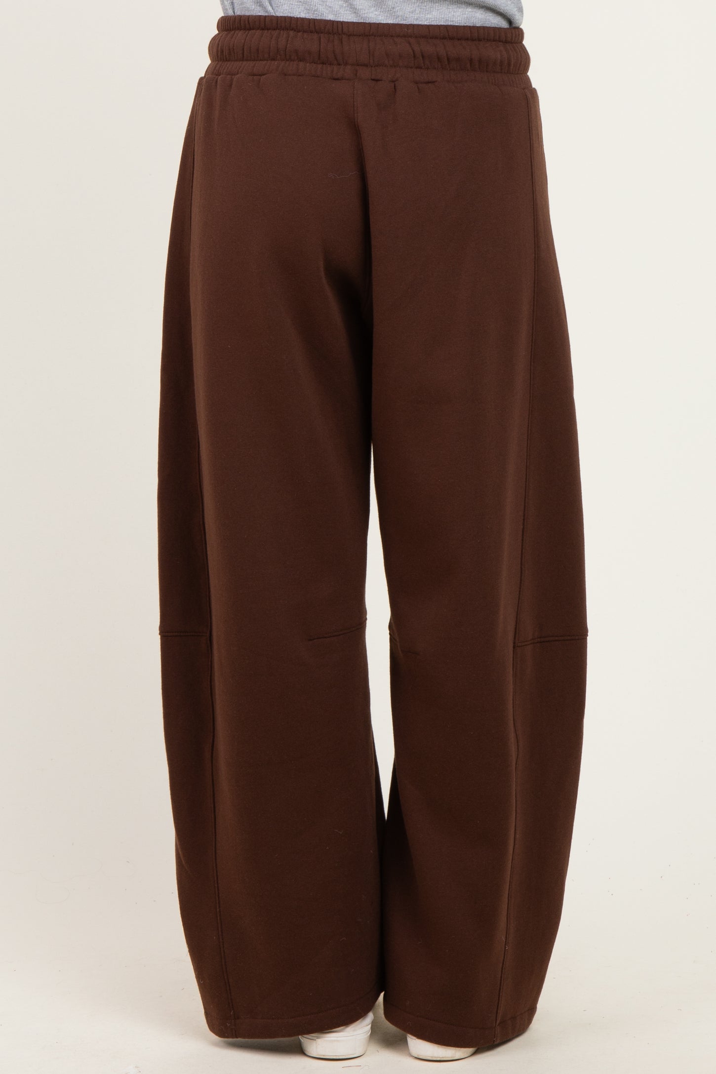 woman wearing brown wide-leg sweatpants with an elastic waistband and side pockets