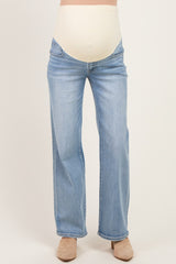 woman wearing light blue maternity jeans with a beige over-the-belly panel
