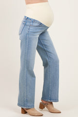woman wearing light blue maternity jeans with a supportive over-the-bump waistband and a visible baby bump