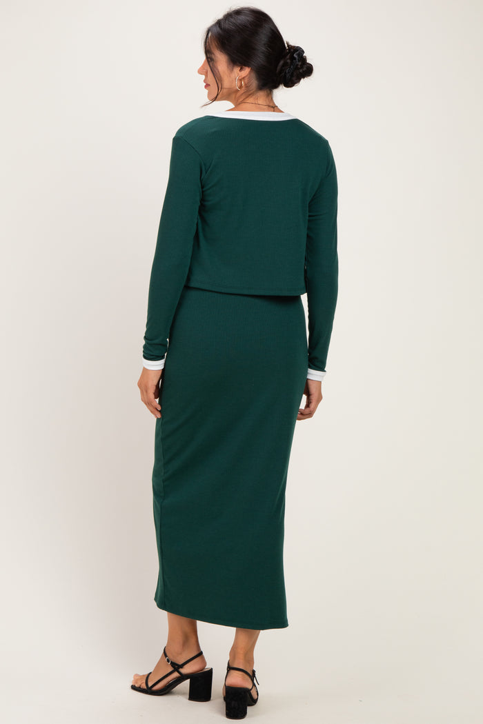 woman wearing a green ribbed two-piece dress with a cropped top and long skirt, showing the back view