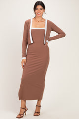 woman wearing a brown ribbed maxi dress with a white trimmed cardigan and strappy heels