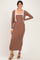 woman wearing a brown ribbed maxi dress with a white trimmed cardigan and strappy heels