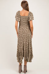 woman wearing a brown floral print maternity dress with short puff sleeves and a ruffled hem